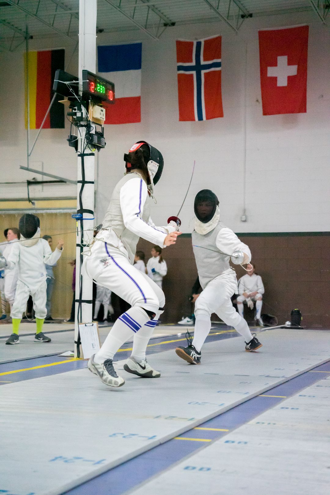 foil fencer lunging at opponent